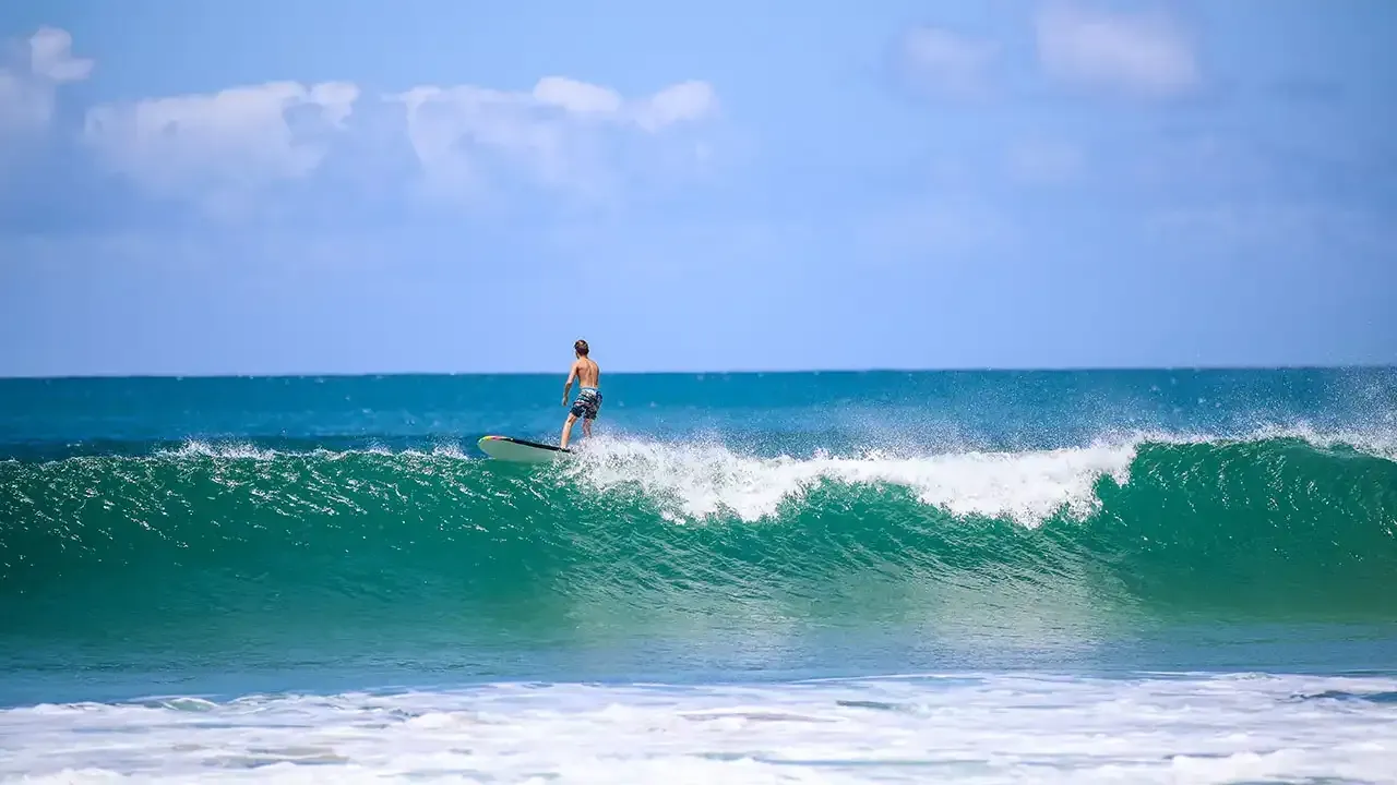 Surfing on Hanalei Bay, Kauai, Hawaii.