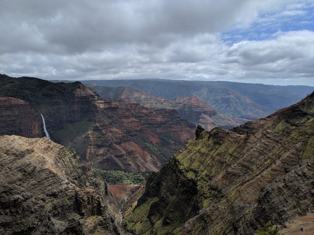 There is a waterfall in the middle of the canyon.