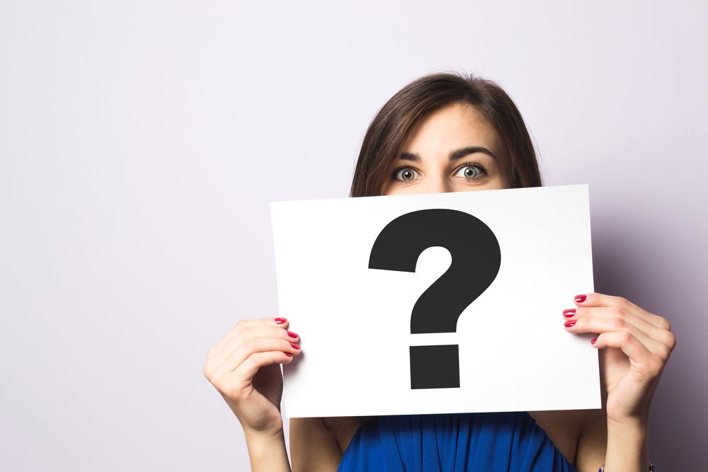 Woman Holding A Question Mark — Financial Advisor In Dubbo