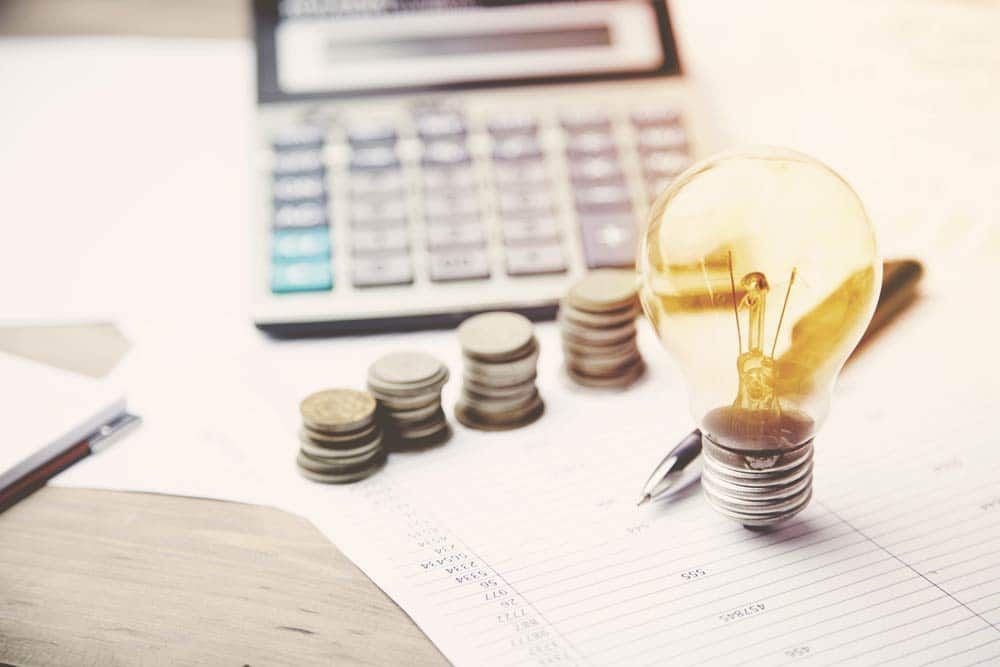 Calculator, Coin and Light Bulb — Financial Advisor In Dubbo