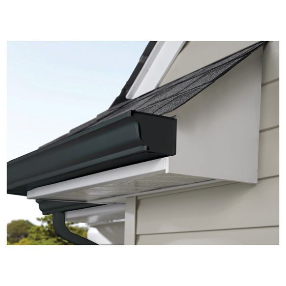 A white house with a black gutter on the side