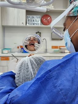 Manos enguantadas colocando instrumental quirúrgico en una bandeja estéril en un quirófano.