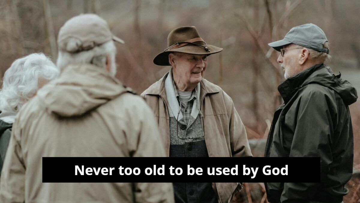 A group of older men are standing next to each other and talking.