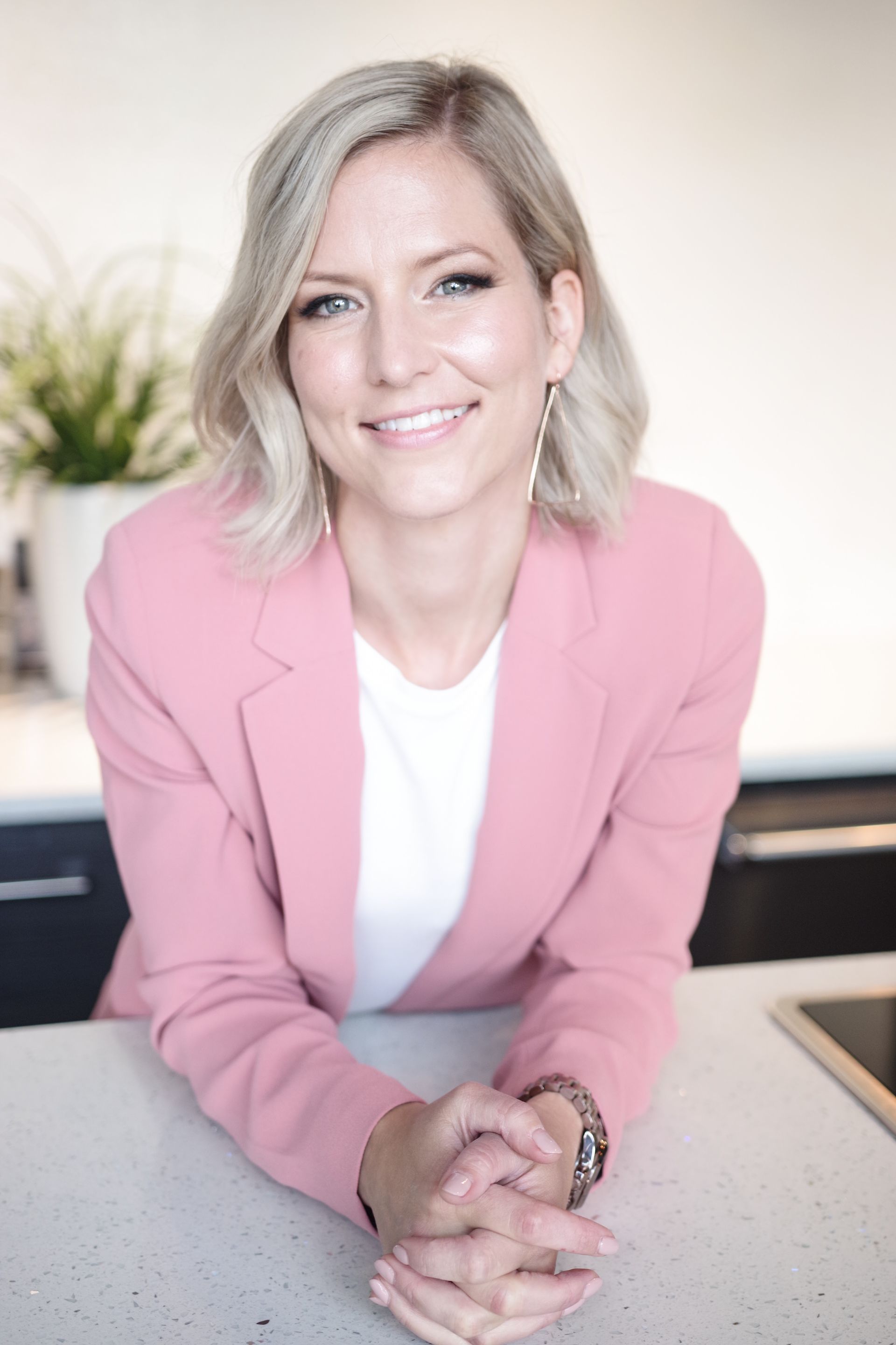 a woman with long dark hair is smiling and wearing a black shirt .