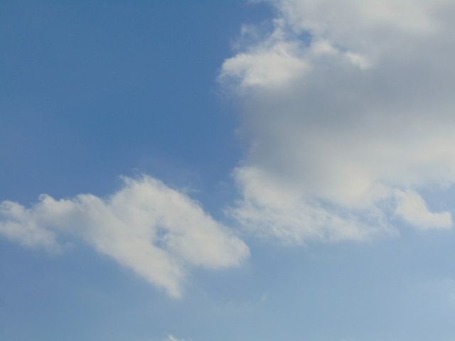 A blue sky with white clouds in it