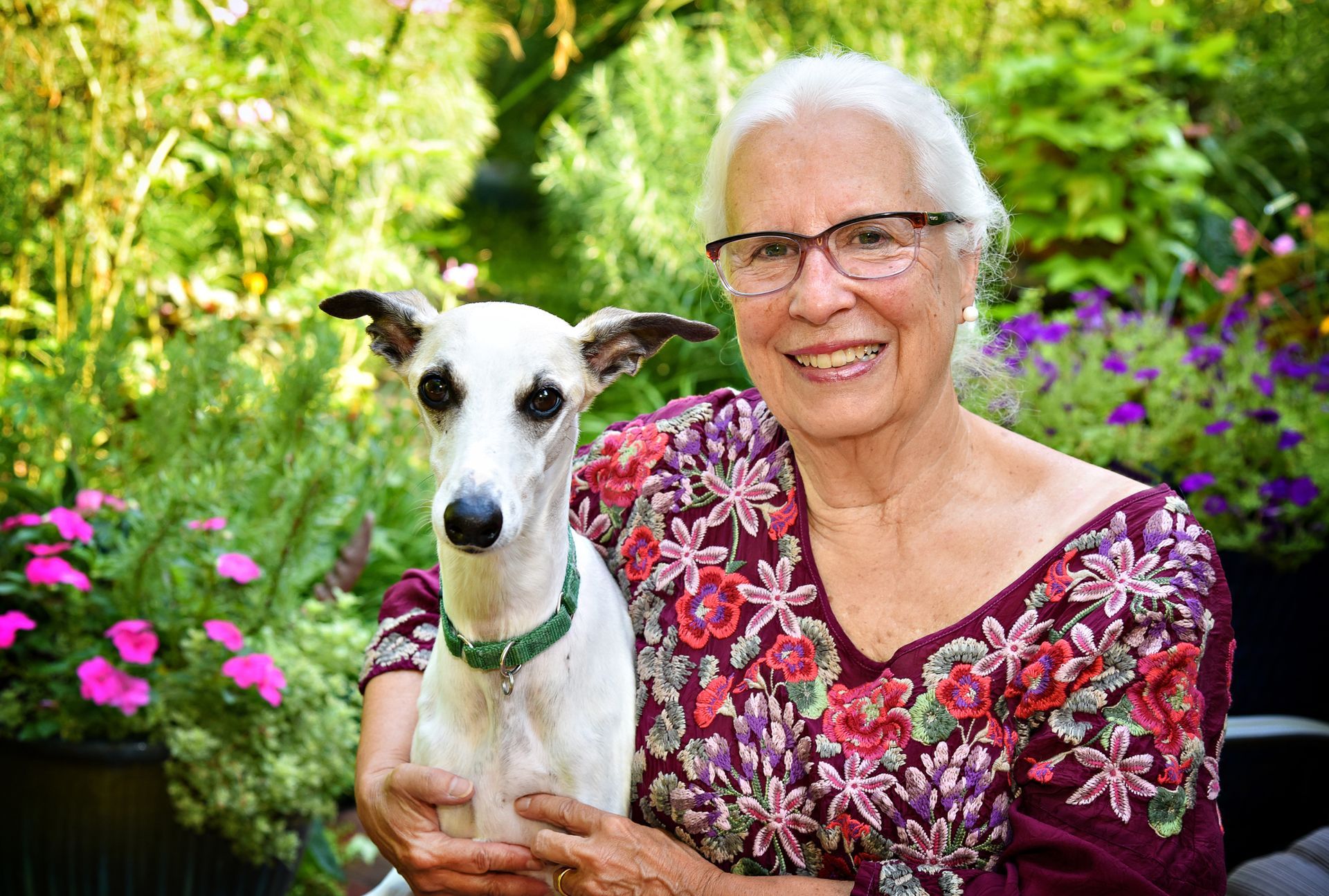 Employee kneeling with Therapy Pets at the Hospital