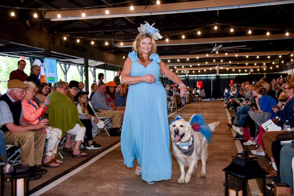 Formal dressed Derby runway model with pegasus winged golden retriever