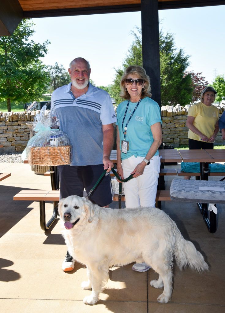 Winner of Raffle with Fundraising Chair and a Golden Retriever