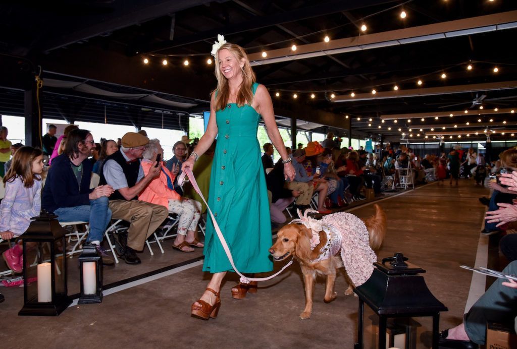 Runway with owner and dress wearing golden retriever