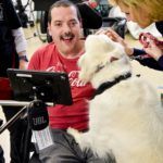 Excited Cedar Lake Resident laughs at a therapy dog