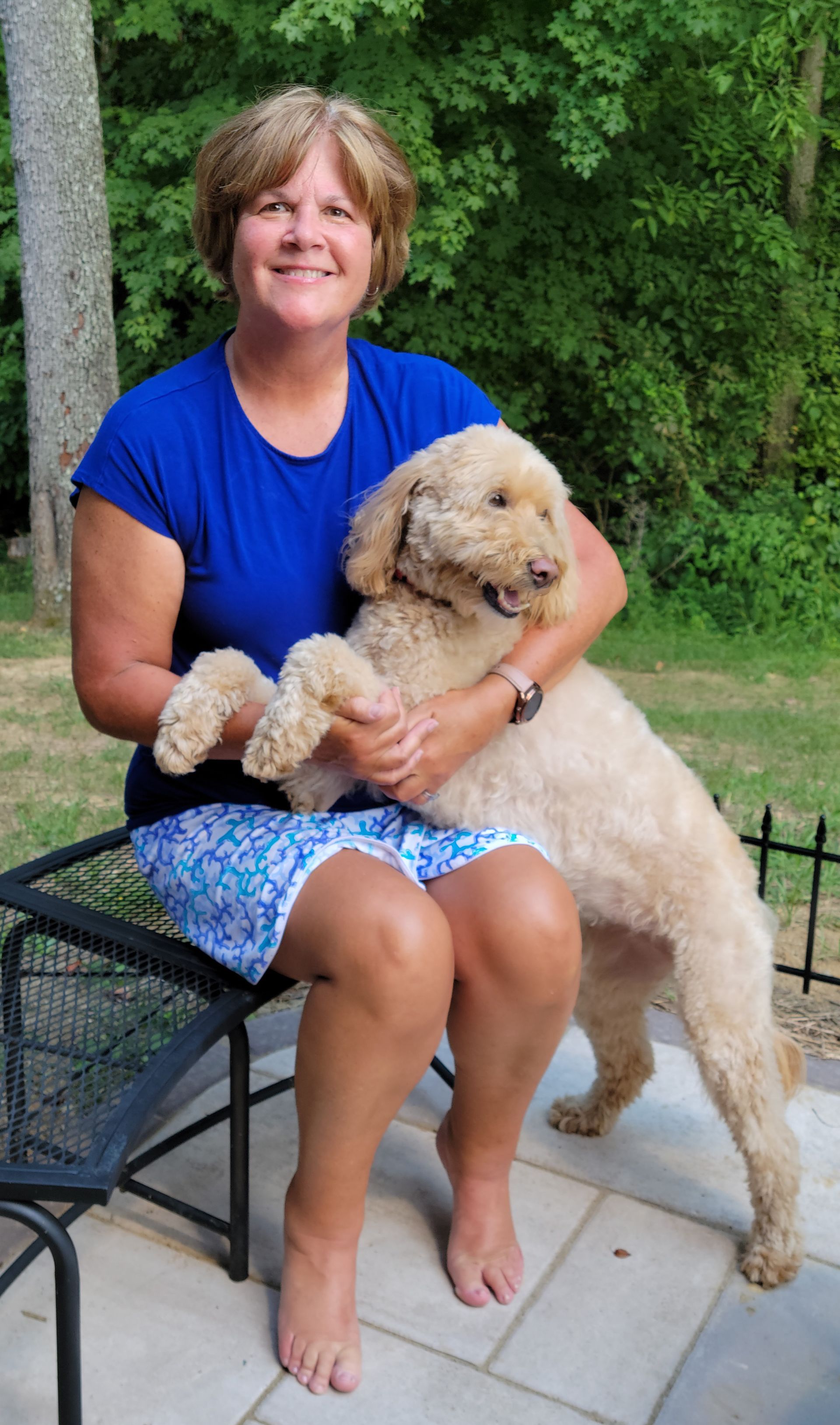 Nancy with Maggie her therapy pet resting on her lap