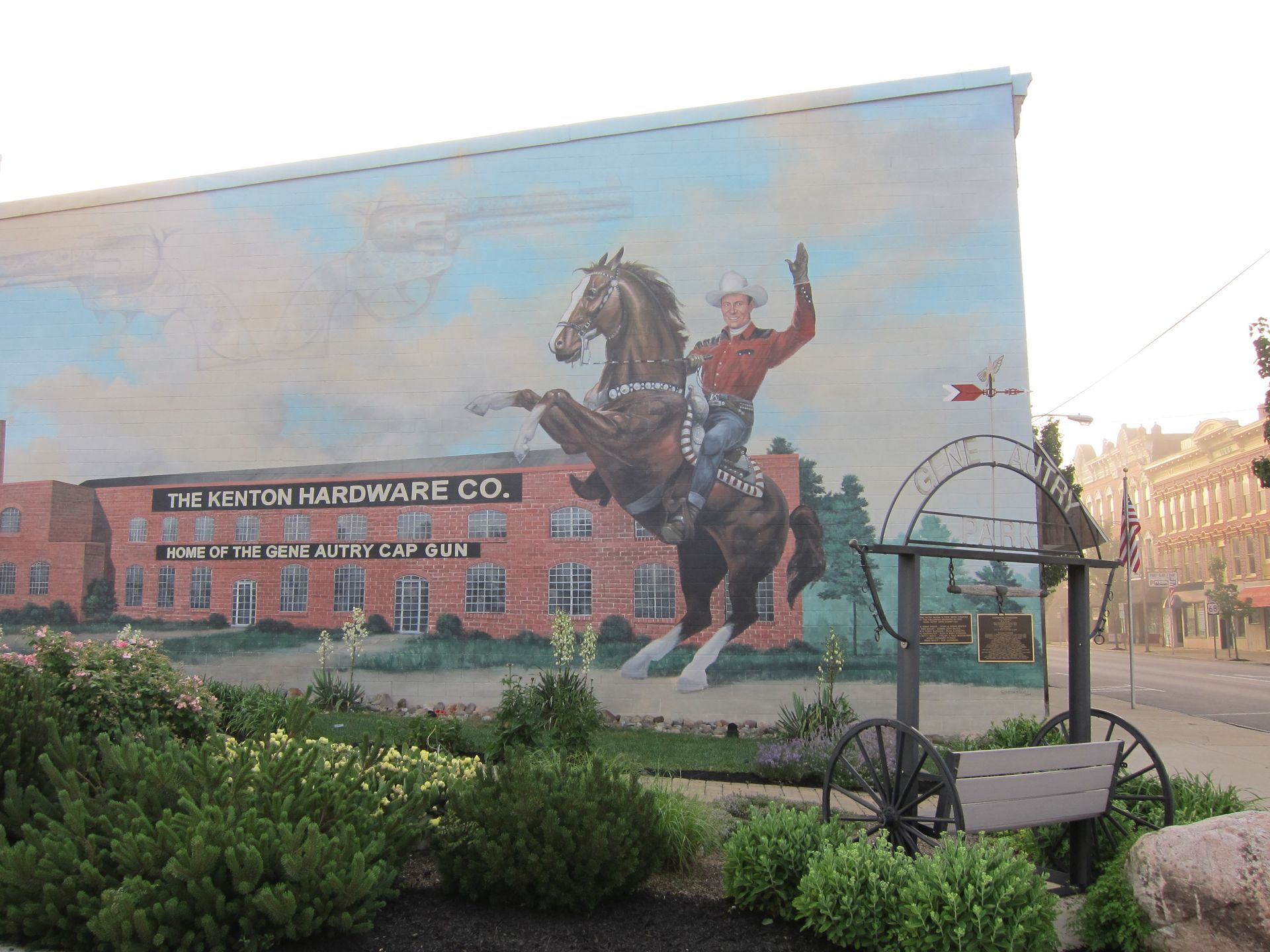 A brown and white horse is standing next to a fence.