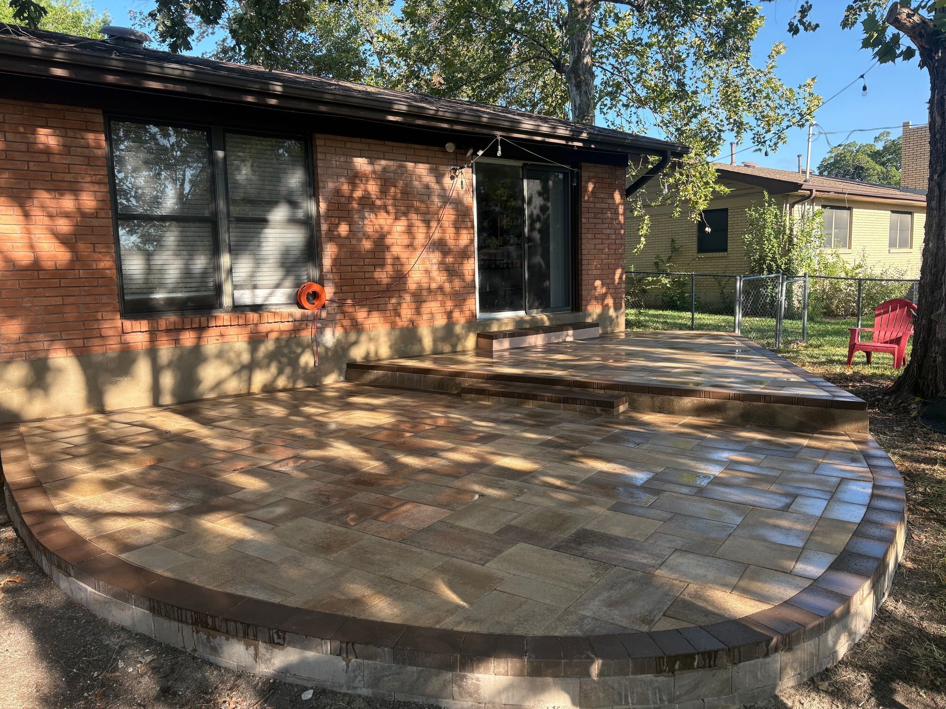 A skilled construction worker carefully placing bricks in a masonry wall using a trowel.