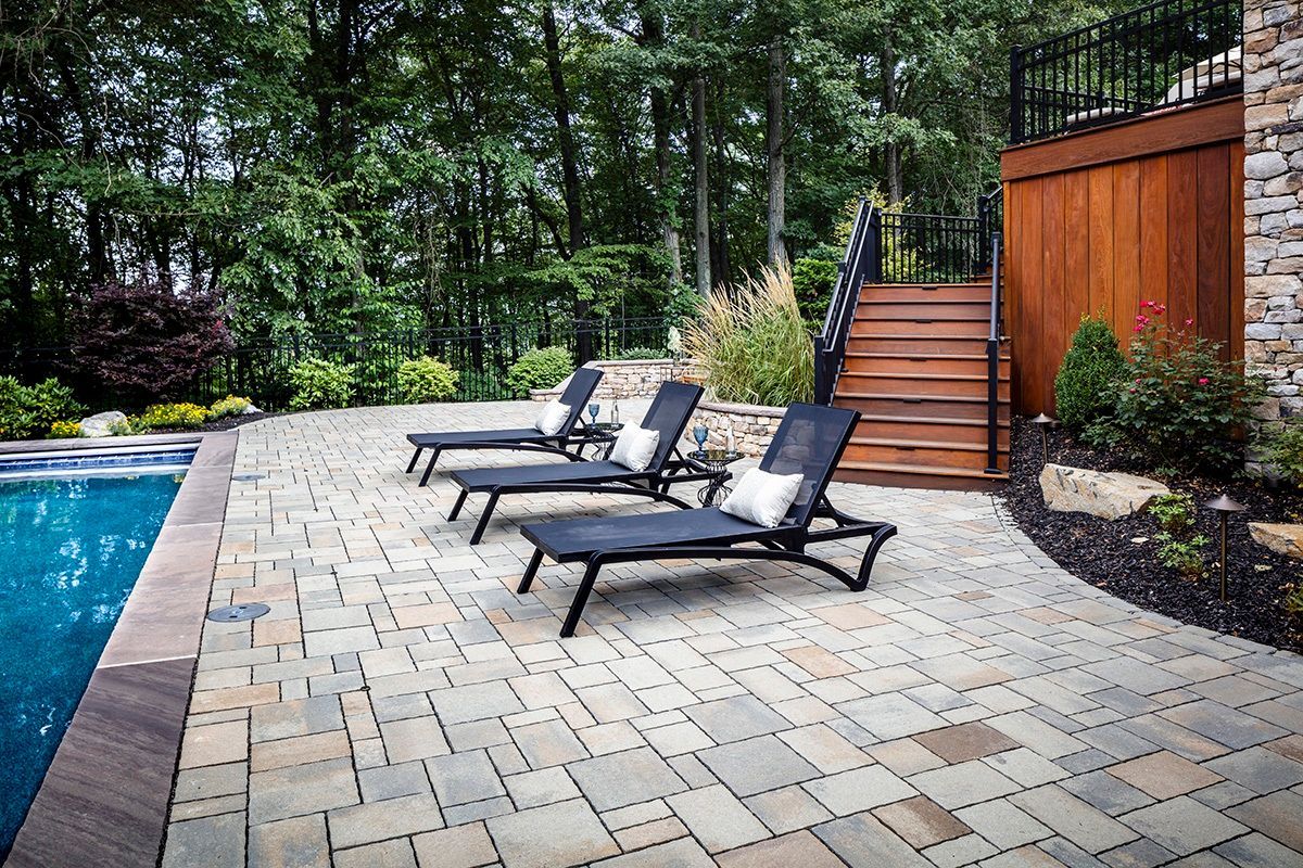 A man is working on a brick wall with a hammer.