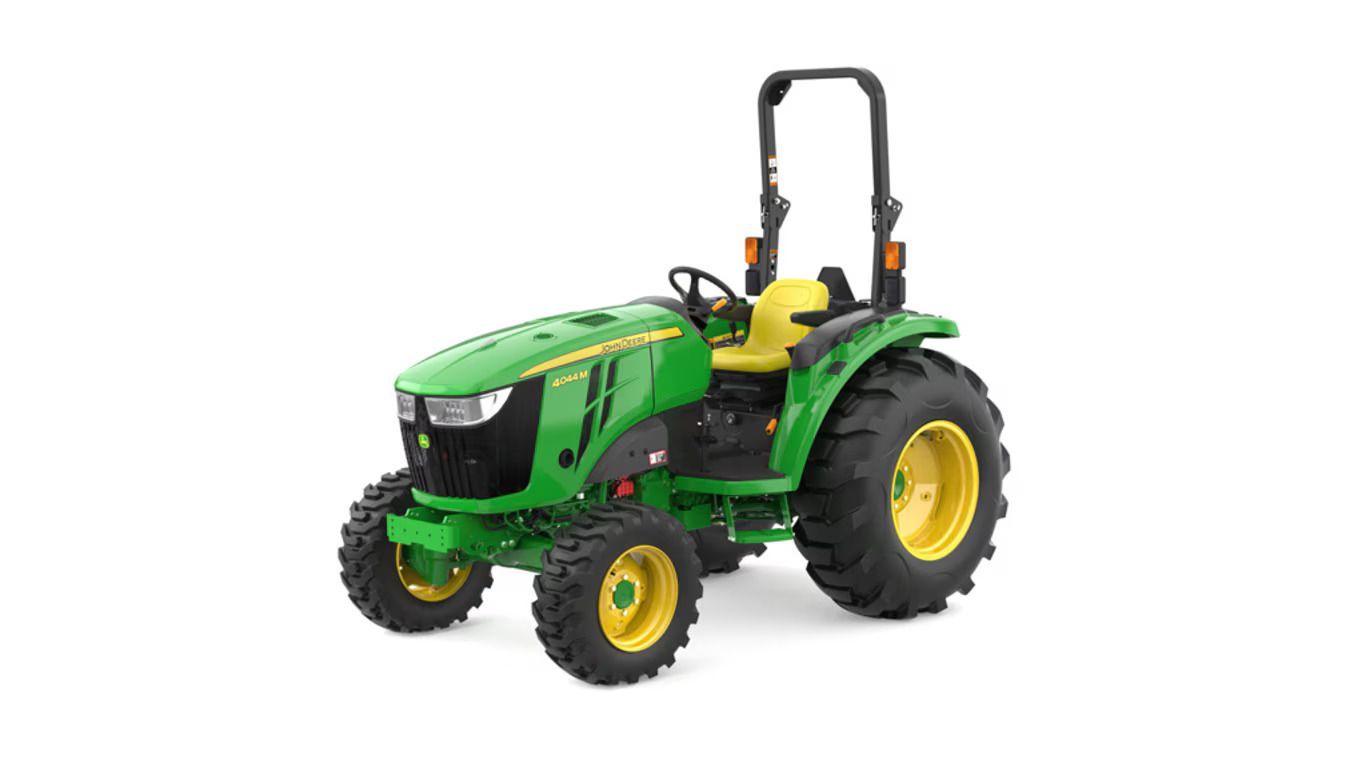 A green John Deere 4044M compact tractor with large black tires and a yellow seat, shown against a plain white background.