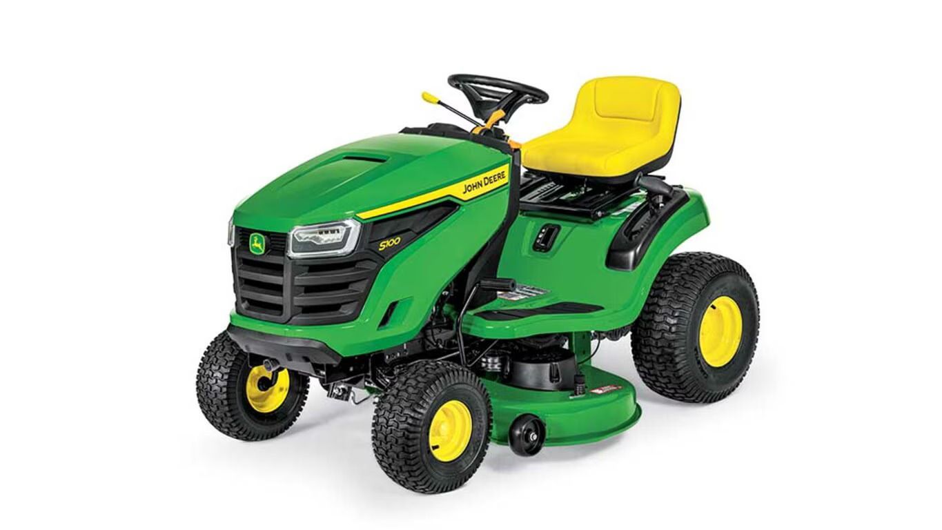 A green and yellow S100 John Deere riding lawn mower viewed from a front-side angle against a white background.