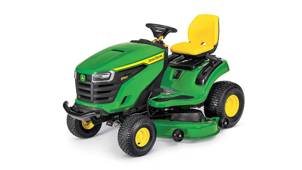 A green and yellow John Deere S140 riding lawn mower viewed from the front right against a white background.
