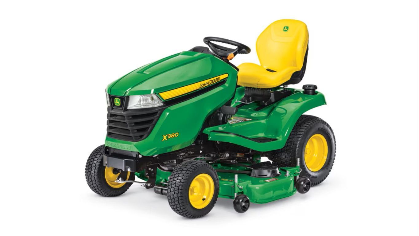 A green and yellow John Deere Z330M zero-turn riding lawn mower on a white background.