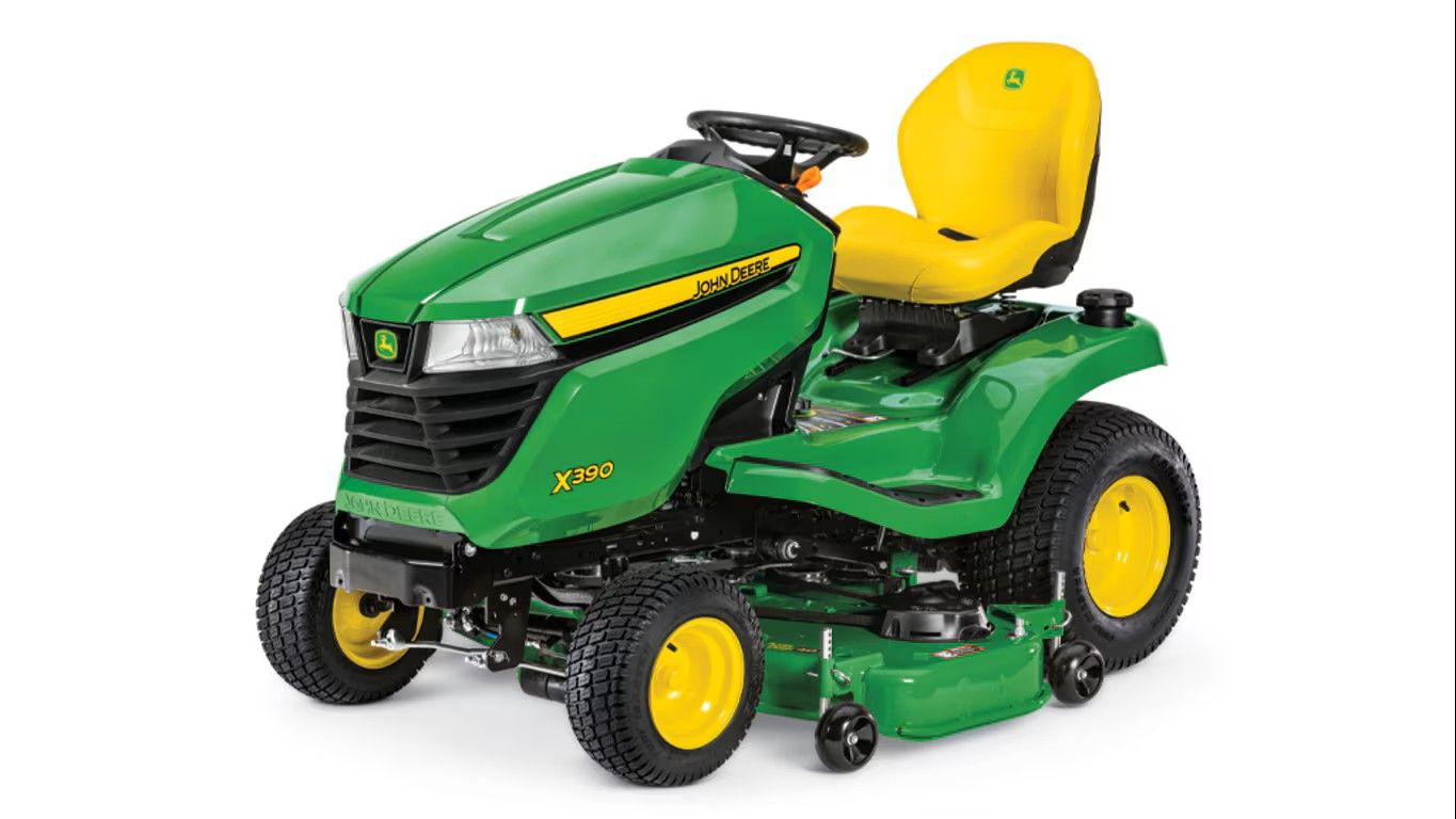 A green and yellow John Deere Z330M zero-turn riding lawn mower on a white background.