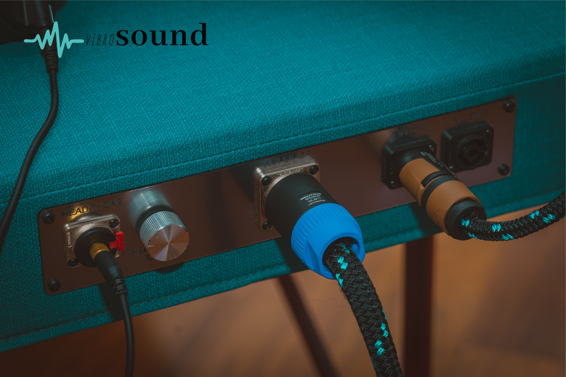 Three medical staff at a reception desk. One woman speaks on the phone, two others look on, clinic sign behind.