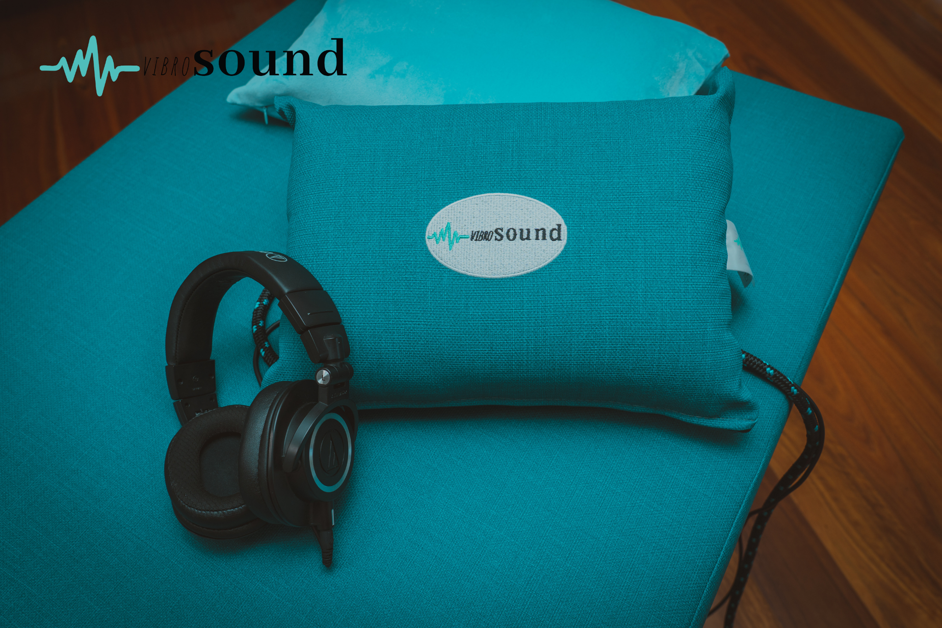 Woman lying down with eyes closed, undergoing sound healing with crystal bowls.