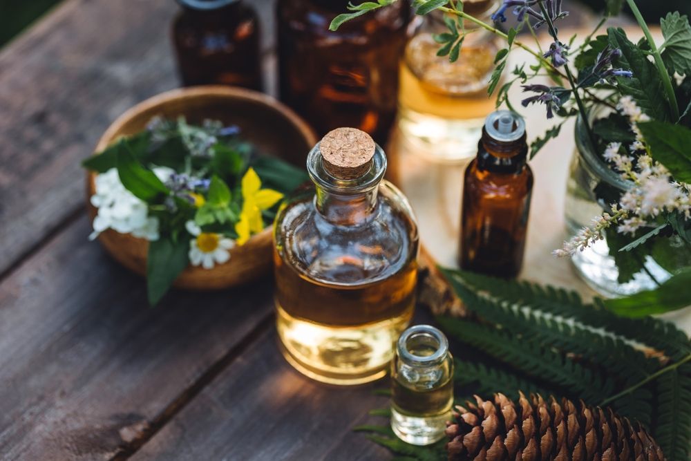 Three people in teal scrubs stand together indoors, smiling.