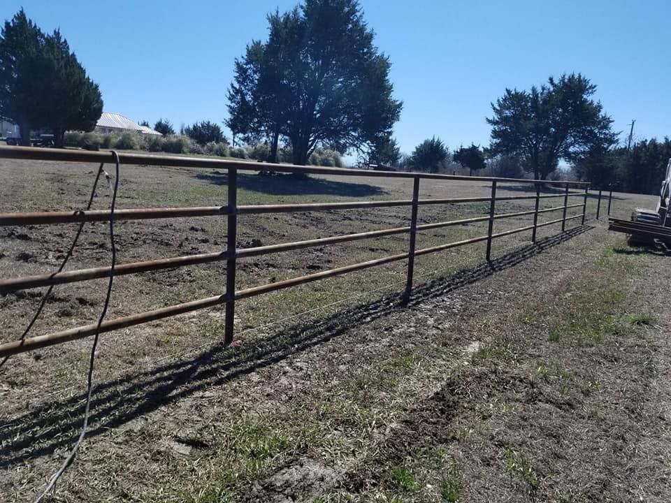 A person holding a baby up in the air indoors near a window, baby smiling.