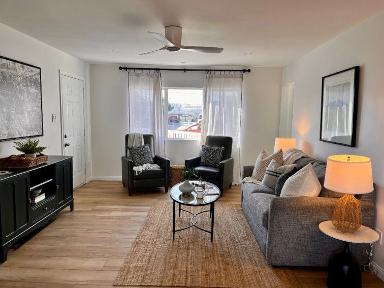 Living room with sofa, armchairs, and rug.  Coral Tree Care Home Assisted Living near Redondo Beach, CA.