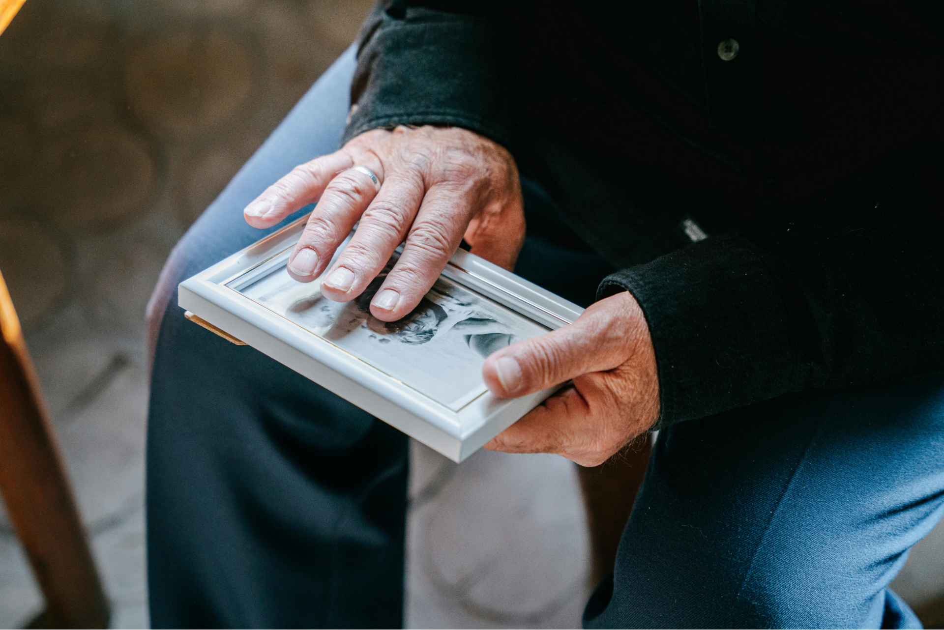 A person's hands holding a framed photo. Coral Tree Care Home assisted living near Palos Verdes, CA.