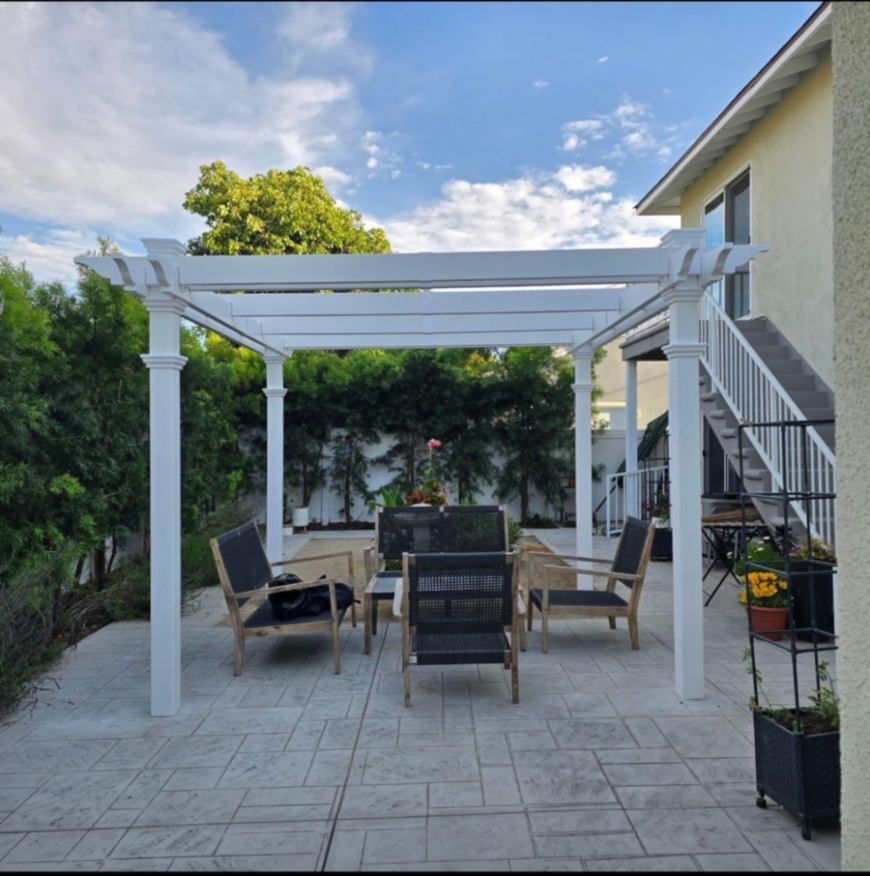 White pergola over patio furniture in a backyard. Senior living in Lomita, CA.