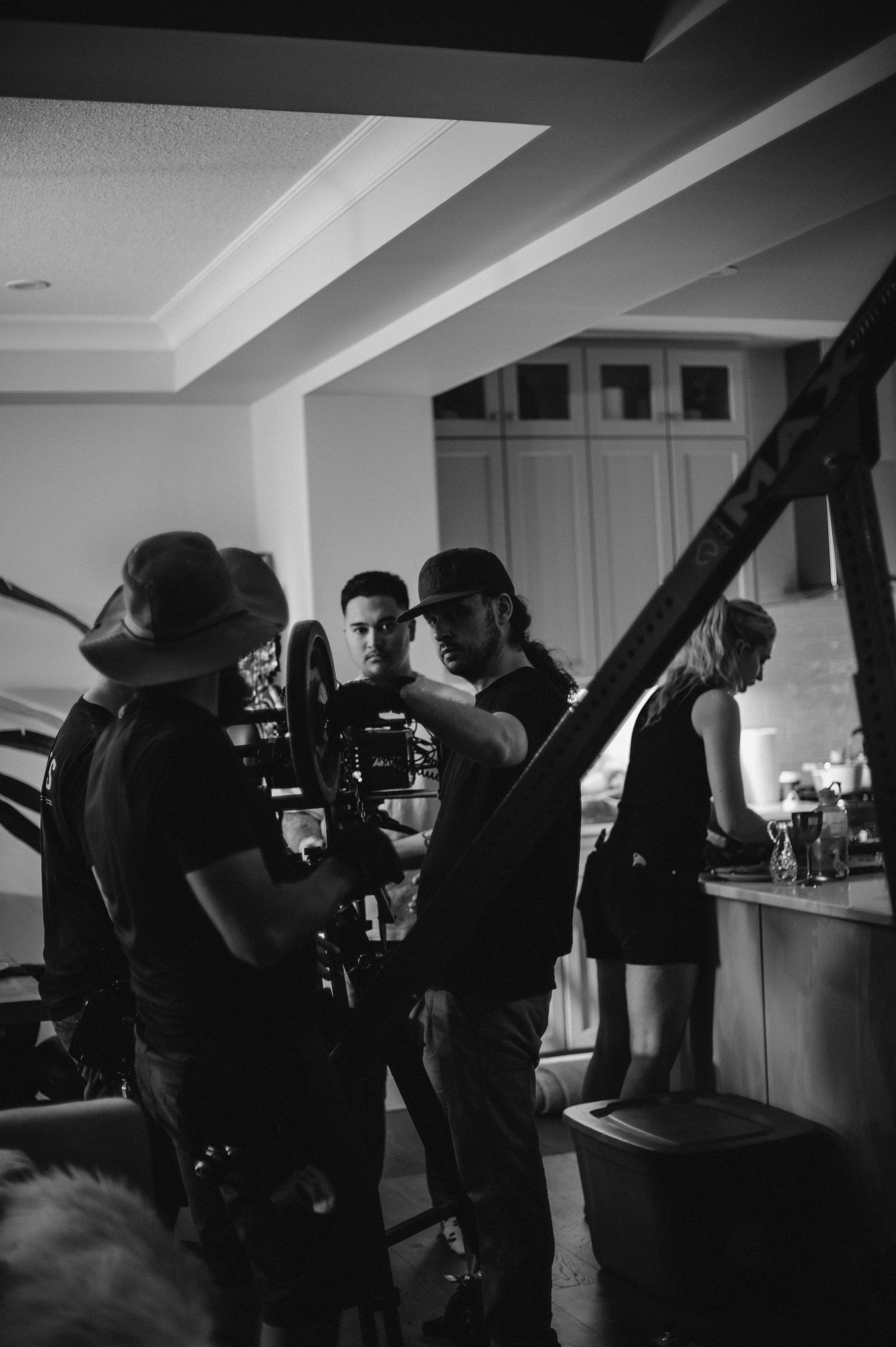 A black and white photo of a group of people standing in a room.