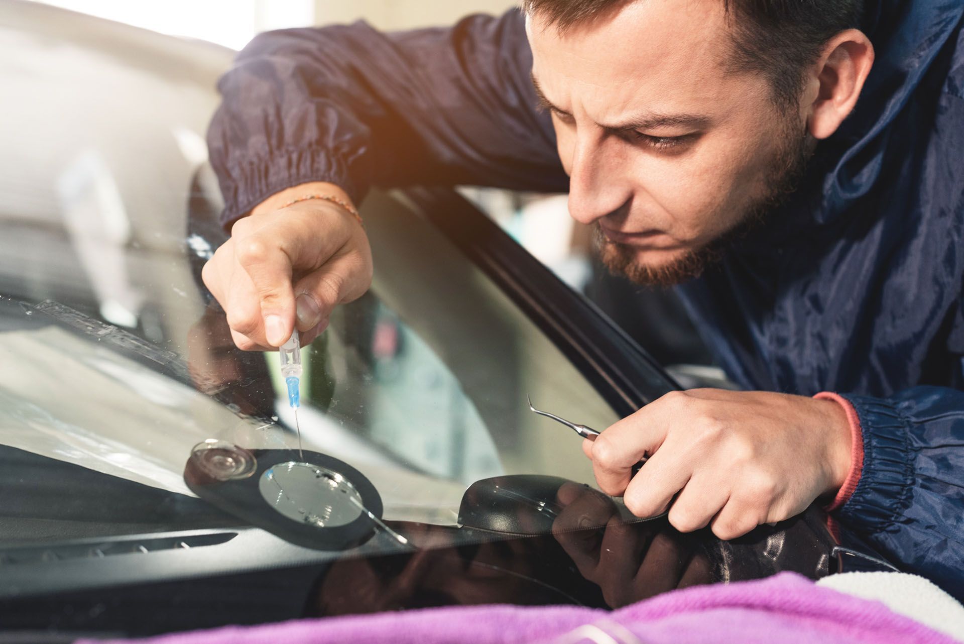 Professional windshield repairman fills a crack in the glass — Fairfield, CA — Peter Pan Auto Glass