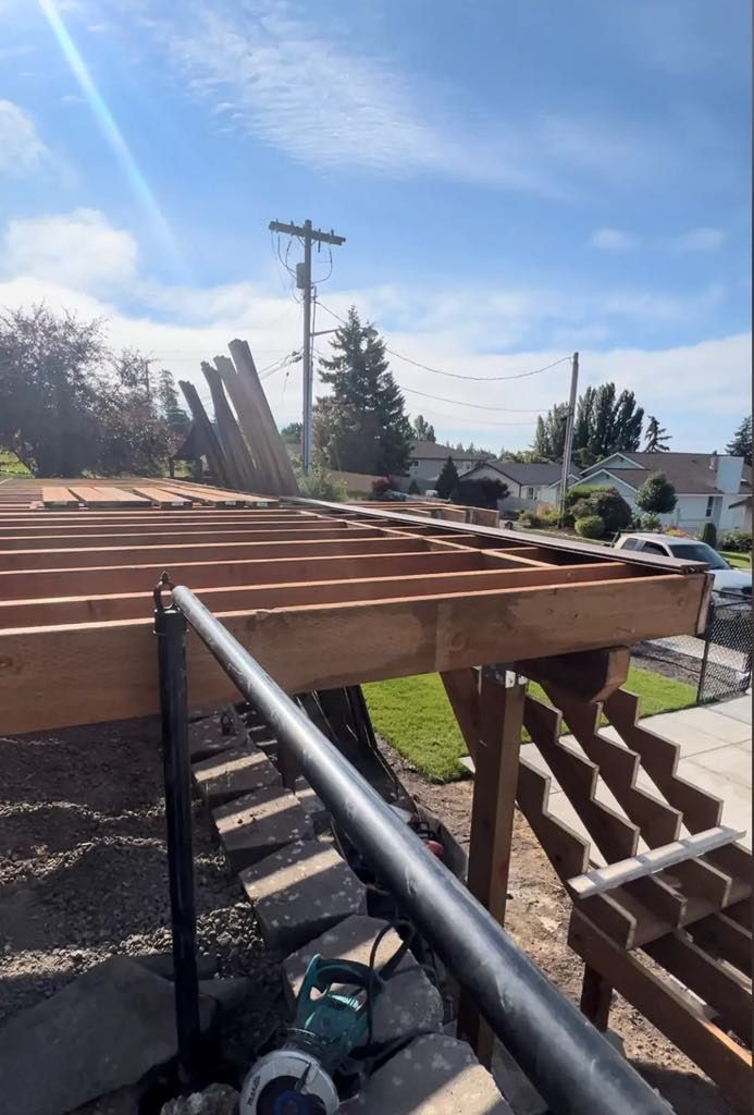 A wooden deck is being built on a sunny day.