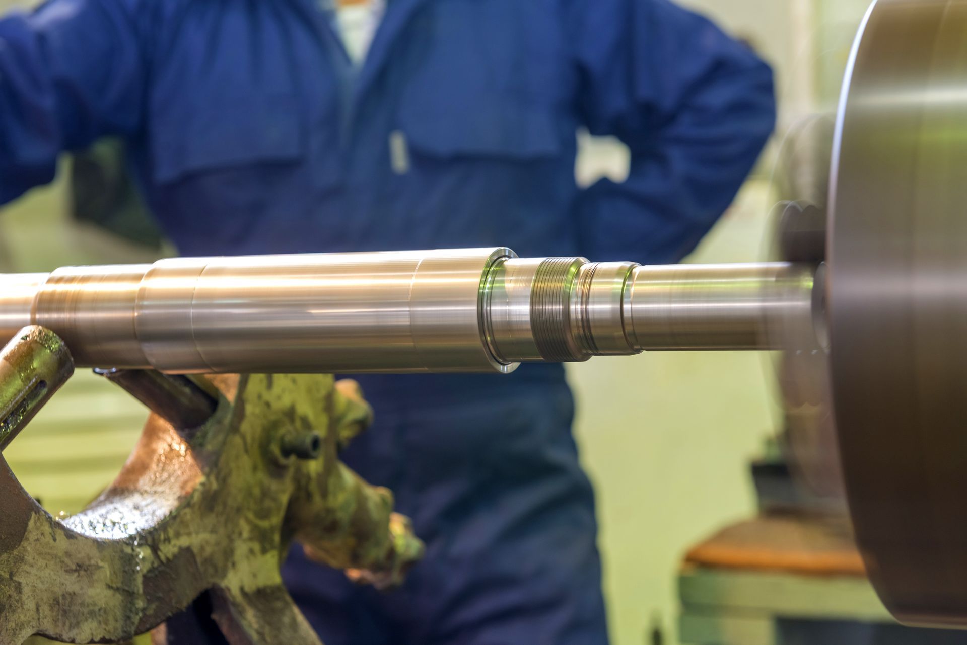 Precision ground stainless steel shaft being checked for total indicator runout