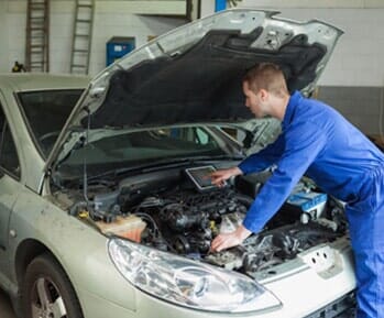 Mechanic Examining Car Engine — Differential Repairs in Denville, NJ Mechanic Examining Car Engine — Differential Repairs in Denville, NJ