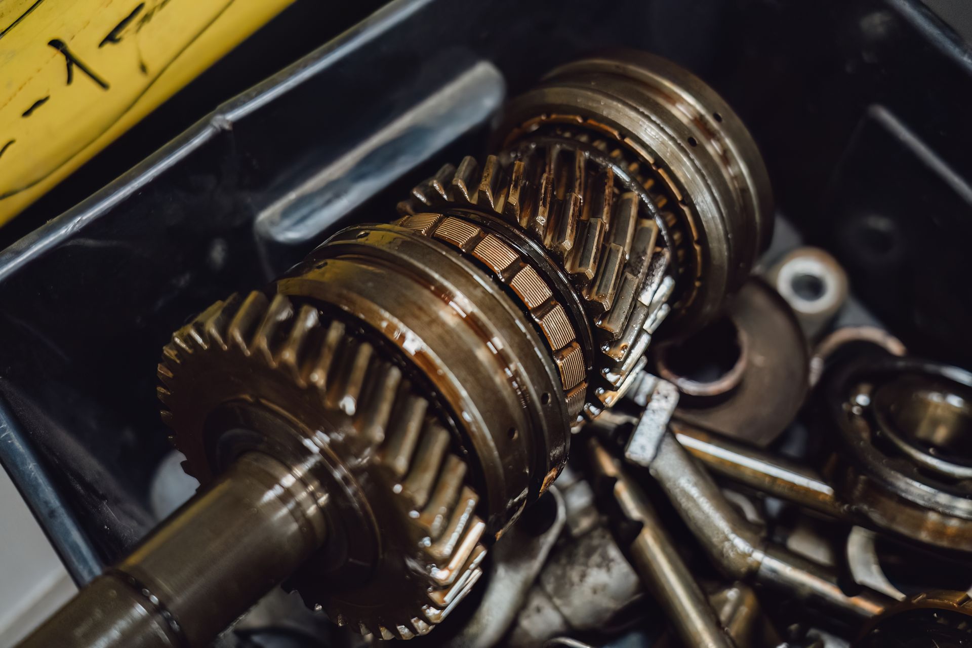 Close-up of gearbox gears during transmission replacement service showing metal parts detailview.
