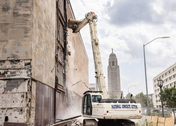 Building demolition contractors using heavy machinery to safely demolish a structure. Building demolition contractors using heavy machinery to safely demolish a structure.