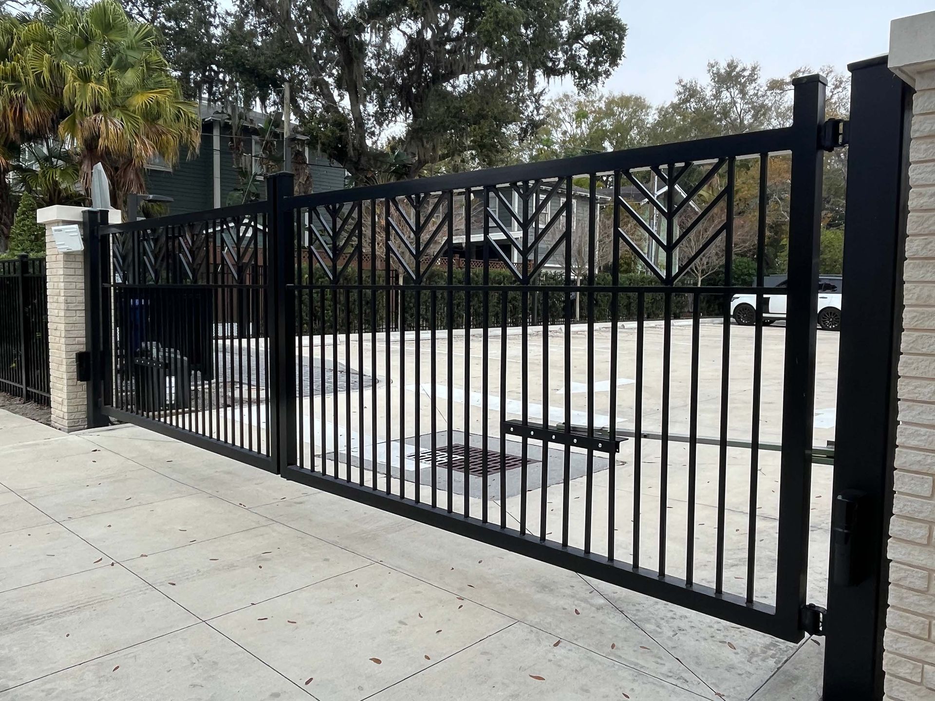 Black metal gate in front of a Chesapeake building with a concrete driveway