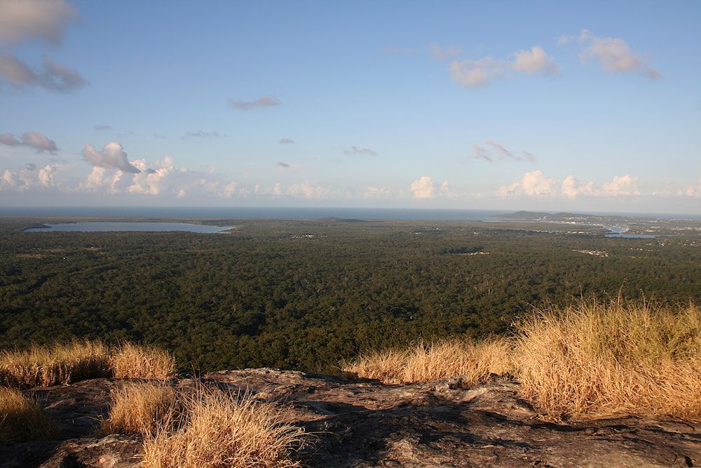 A White Air Conditioner is Mounted on the Side of a Building — Davies Refrigeration & Air Conditioning in Cooroy, QLD