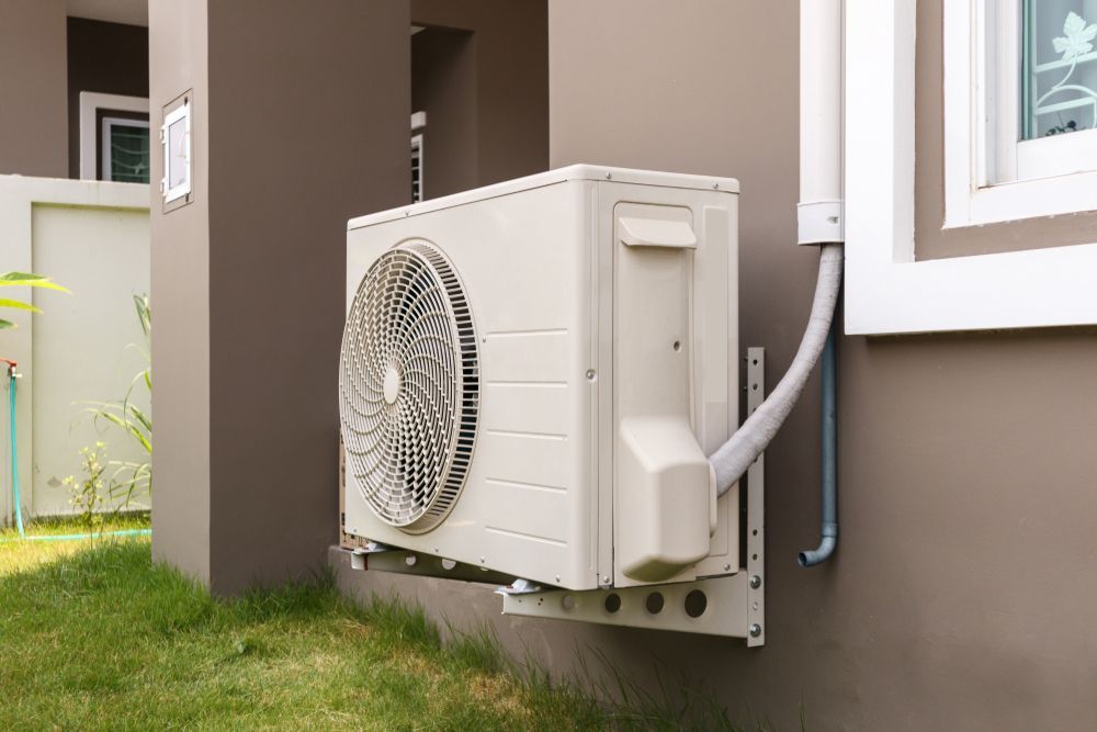 An Air Conditioner is Mounted on the Side of a House — Davies Refrigeration & Air Conditioning in Nambour, QLD