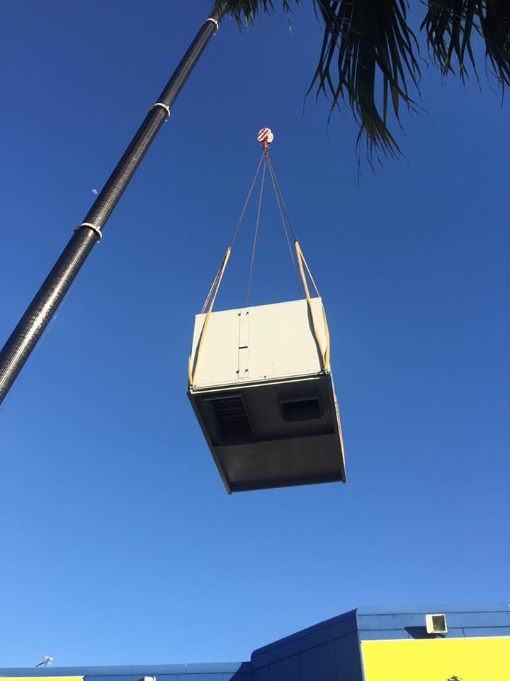 A Large White Box is Being Lifted by a Crane — Davies Refrigeration & Air Conditioning in Warana, QLD
