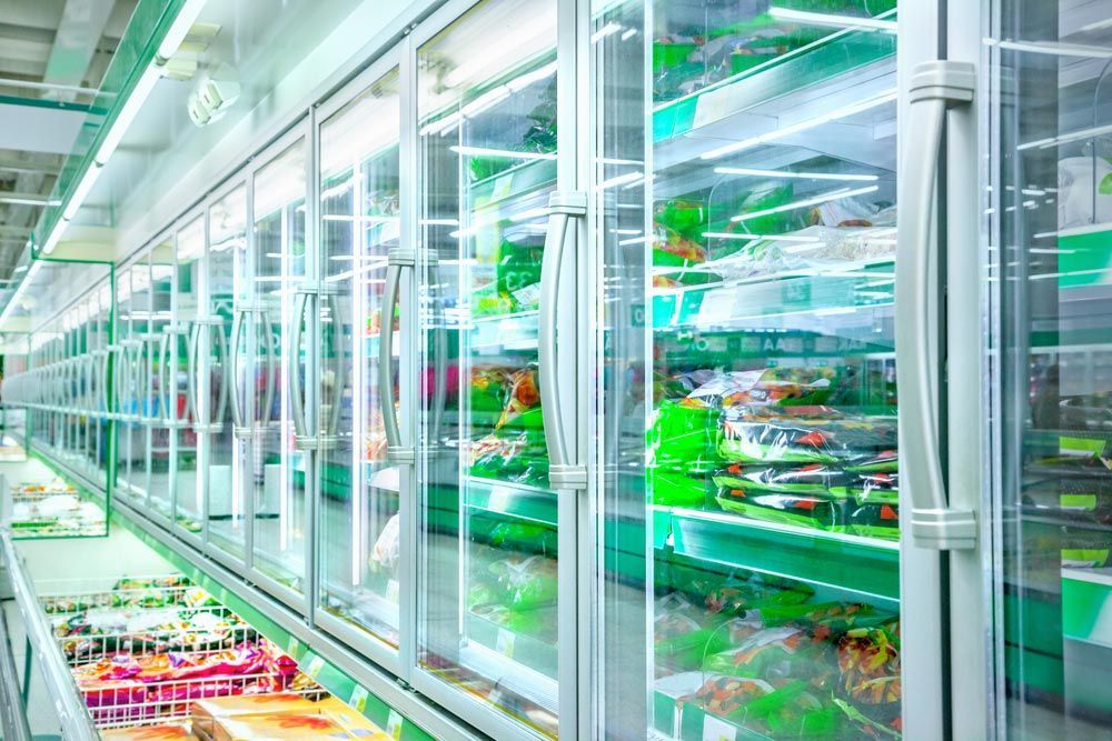 A Row of Refrigerators in a Grocery Store 
 — Davies Refrigeration & Air Conditioning in Warana, QLD