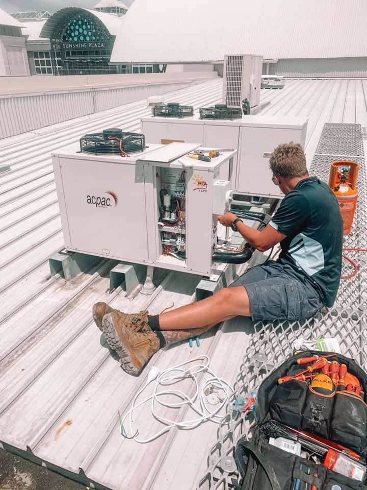 Technician Fixing Air Conditioning System
