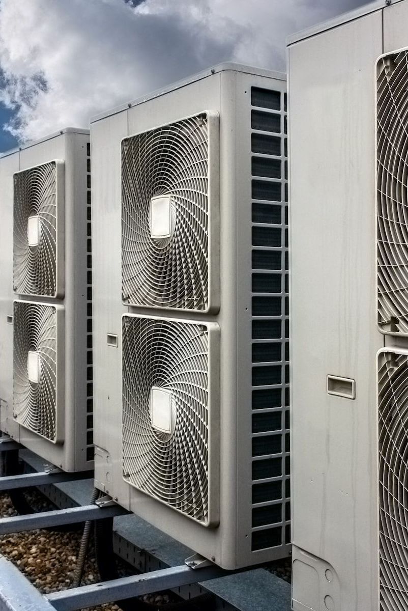 A Row of Air Conditioners Are Sitting on Top of a Building — Davies Refrigeration & Air Conditioning in Warana, QLD