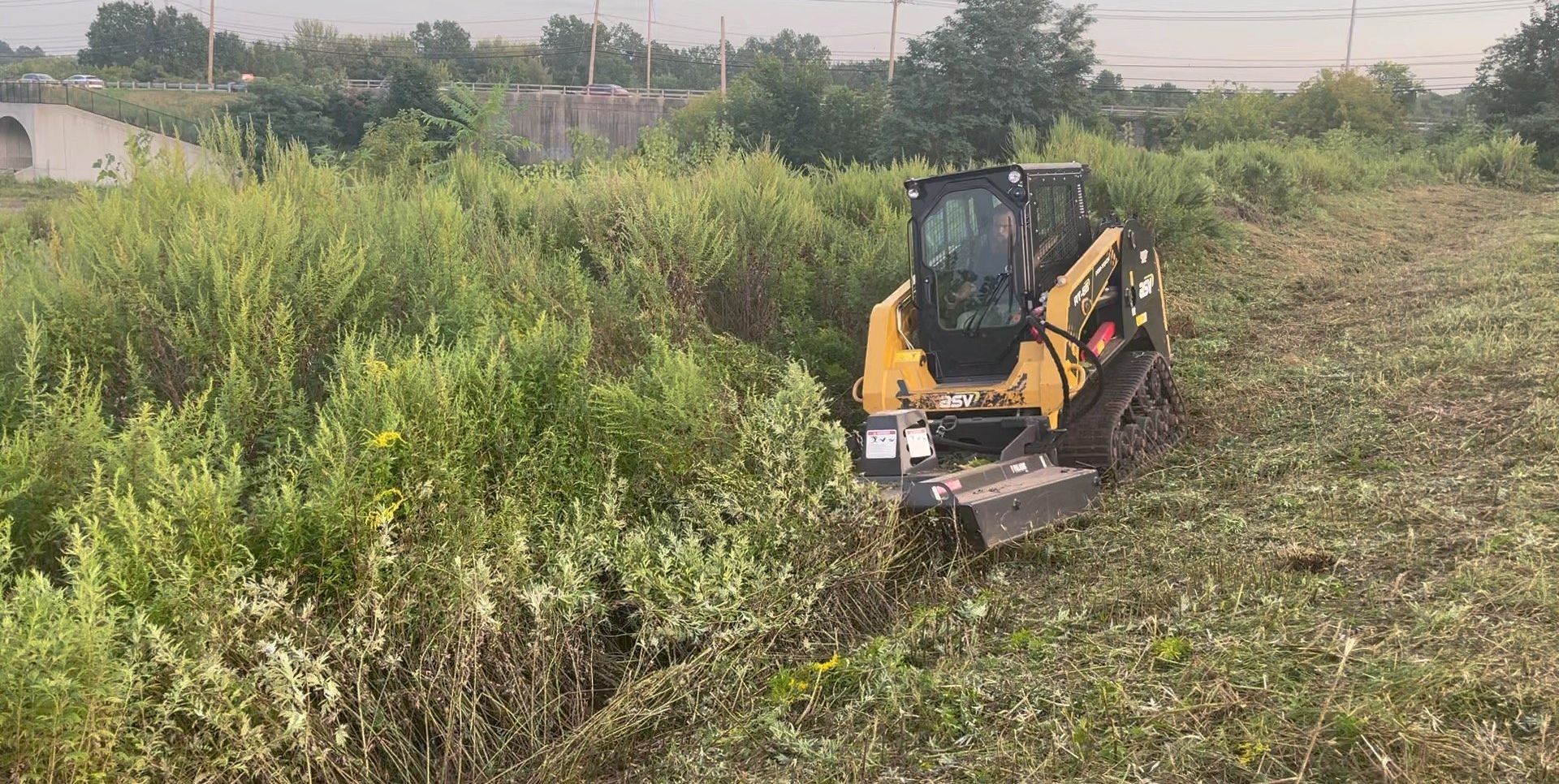 Custom two tier natural boulder wall constructed in West Hartford with Sod Finish, River Rocks, and Planting Installs.