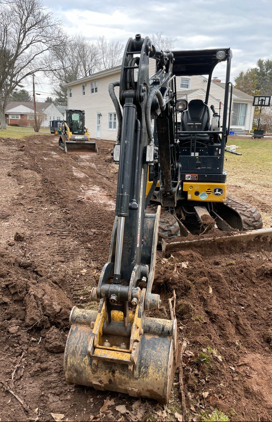 Excavator Excavating Swale with ASV Skid & John Deere 26g Excavator in West Hartford, Connecticut Landscape Solutions