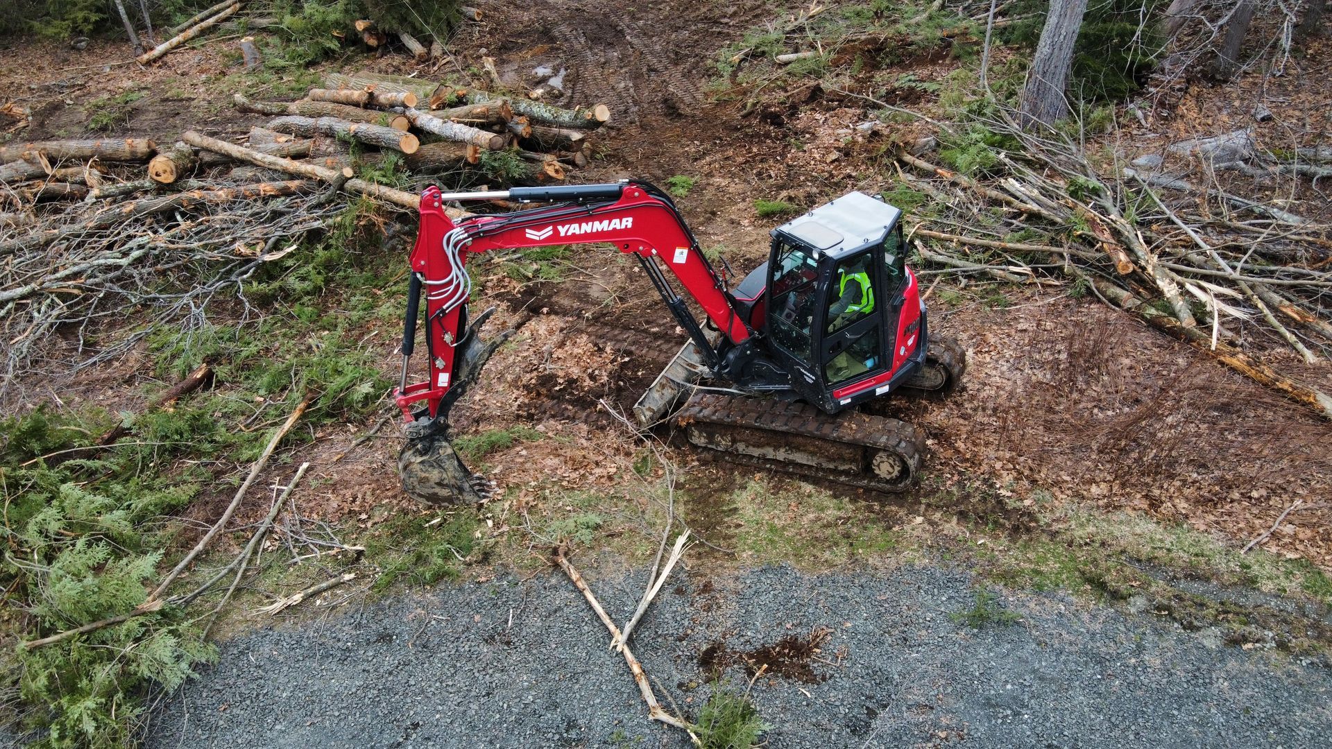Excavator Land Clearing and Digging Stumps with Yanmar SV100 in Simsbury, Connecticut Landscape Solutions