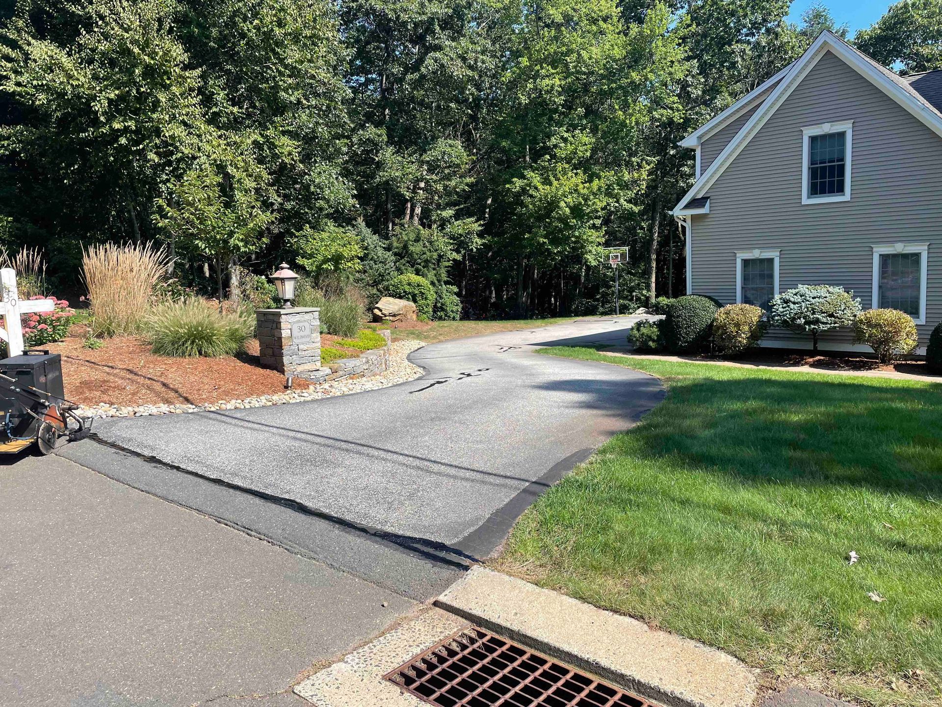 Crack filling older driveway in need or repair, Connecticut Landscape Solutions