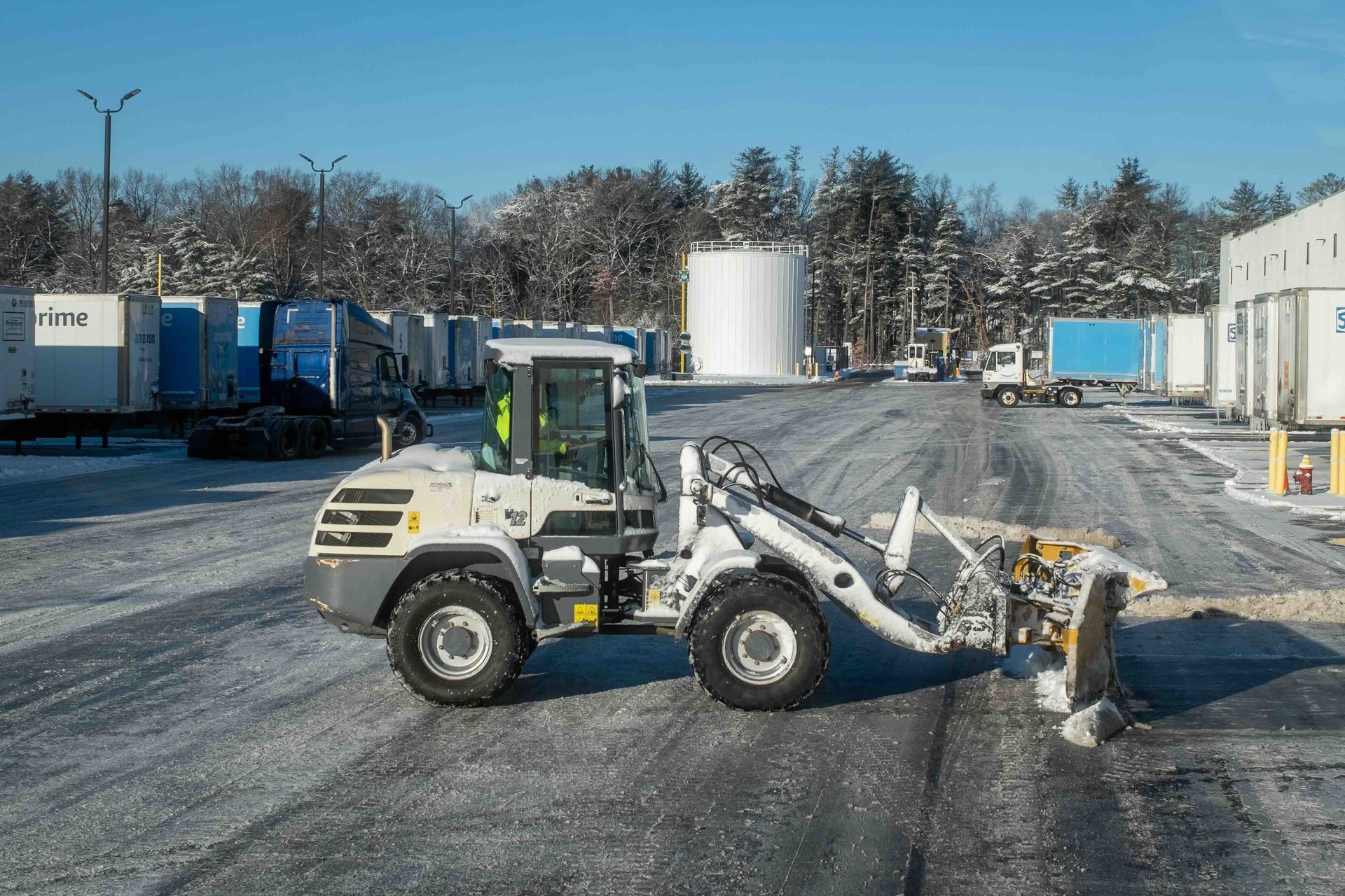 Commercial snow removal contractor in Connecticut Operating Yanmar Loader at Logistics Facility