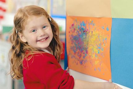 smiling toddler with art